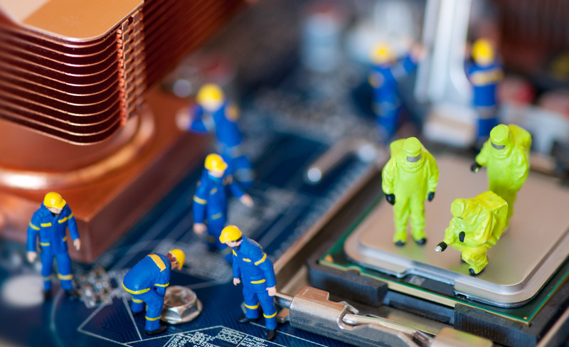 Toy men repairing motherboard